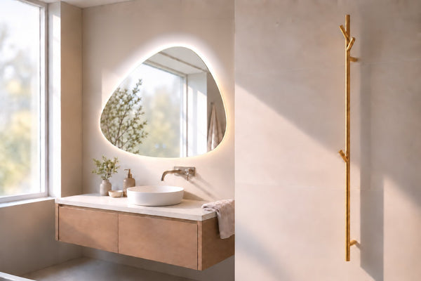 Bathroom with Galaxy frameless backlit LED mirror with motion sensor and gold heated towel rail