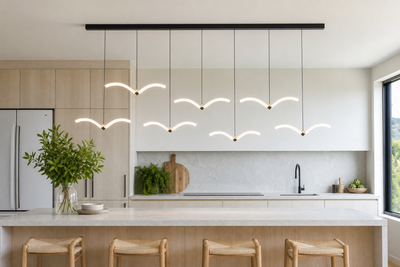 Linear LED bar pendant with seagull-wing lights above a kitchen island