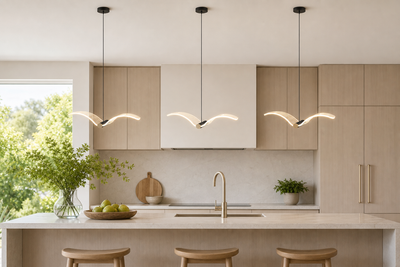 Three single seagull-wing LED pendants above a kitchen island
